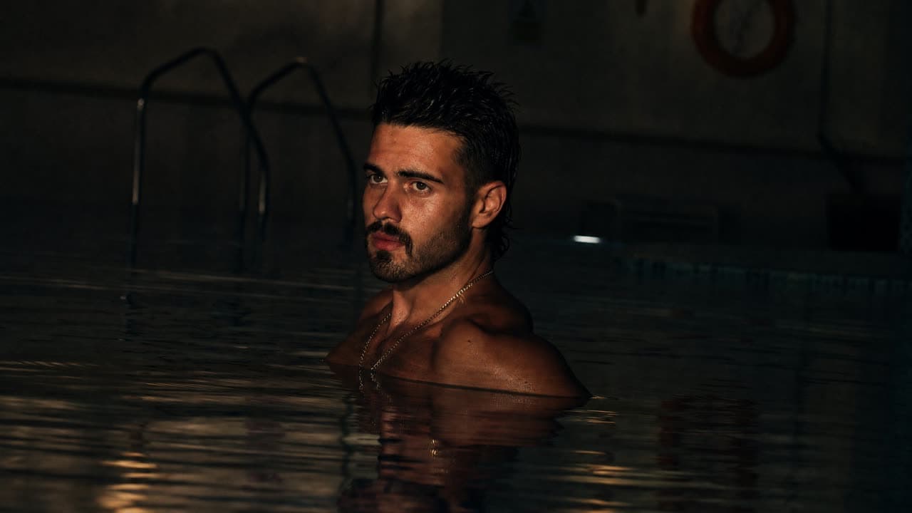 A swimmer's head and shoulders in a pool at night